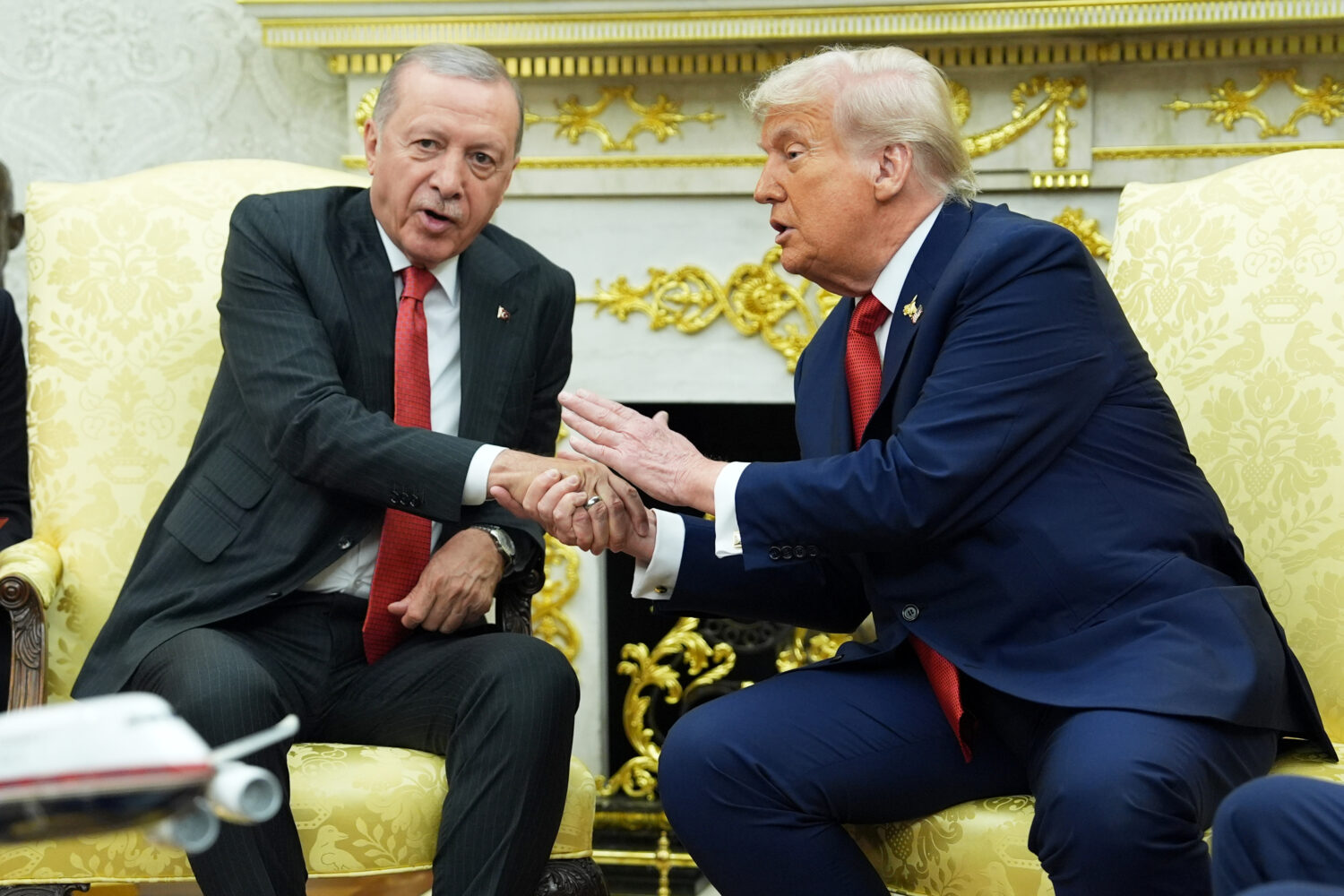 FILE - President Donald Trump, right, shakes hands with Turkish President Recep Tayyip Erdogan duri...