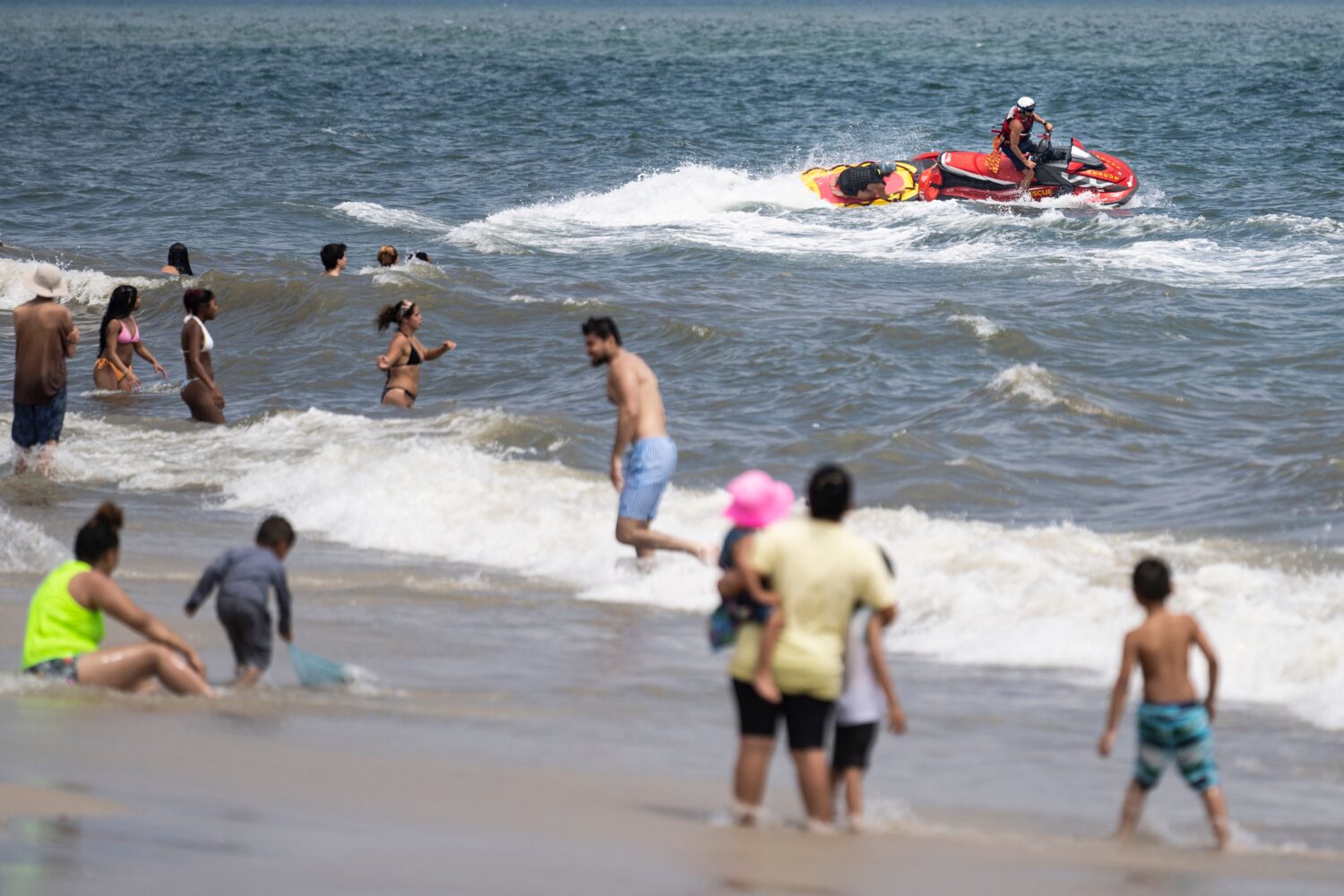 FILE - Lifeguards ride a jet ski during a shark patrol run at Jones Beach State Park, Thursday, Jul...