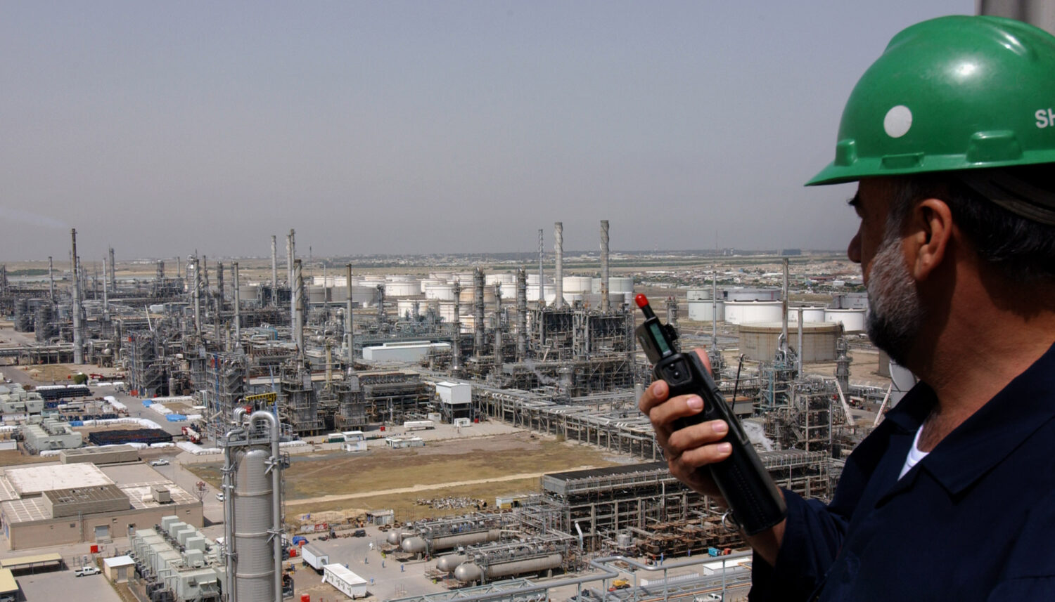 FILE - A Kuwaiti oil worker talks on his radio at Mina Abdulah Oil Refinery, 50 Km South of Kuwait ...