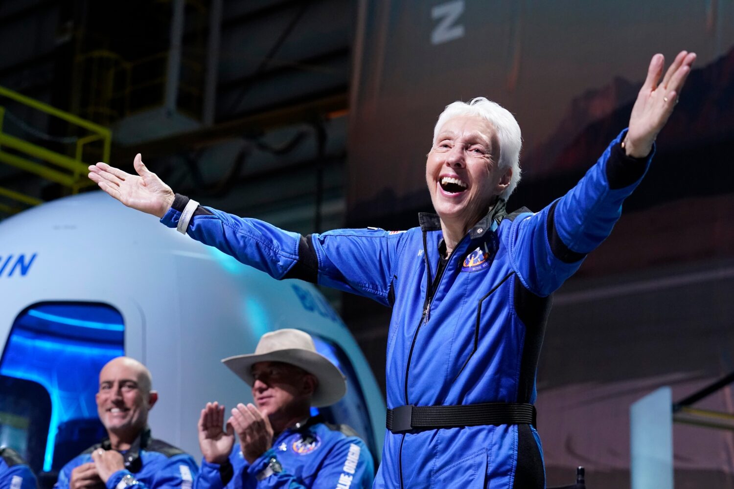 FILE - Wally Funk, right, describes her flight experience as Mark Bezos, left, and Jeff Bezos, left...