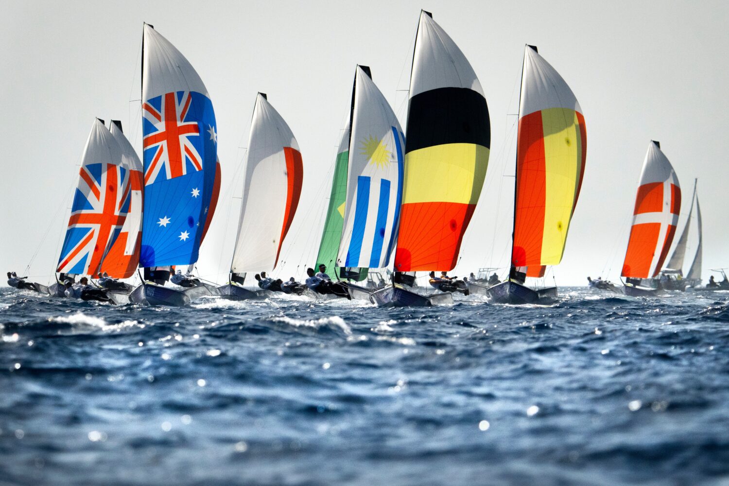 FILE - A fleet of boats from around the world compete in a men's skiff event sailing race Sunday Ju...