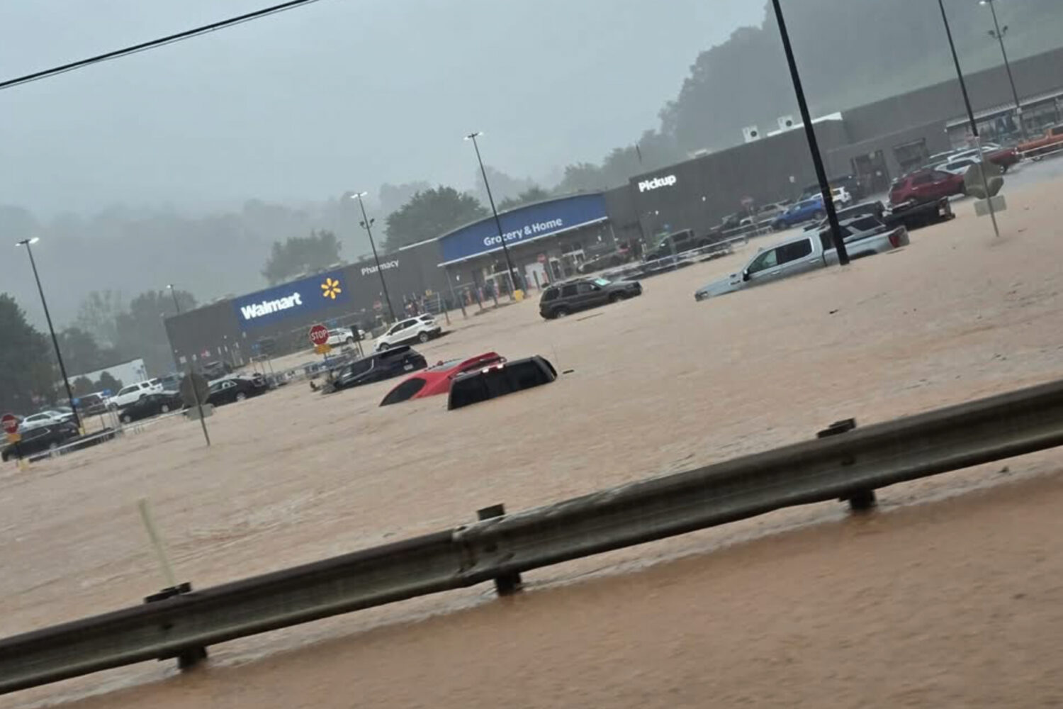 In this photo provided by Alexis Wood, a flooded Walmart parking lot is shown Tuesday, July 21, 202...