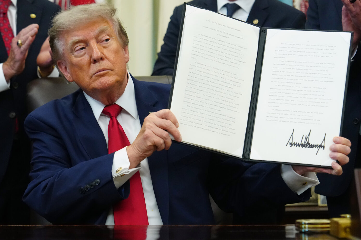 President Donald Trump holds a signed executive order modifying the Bears Ears National Monument in...