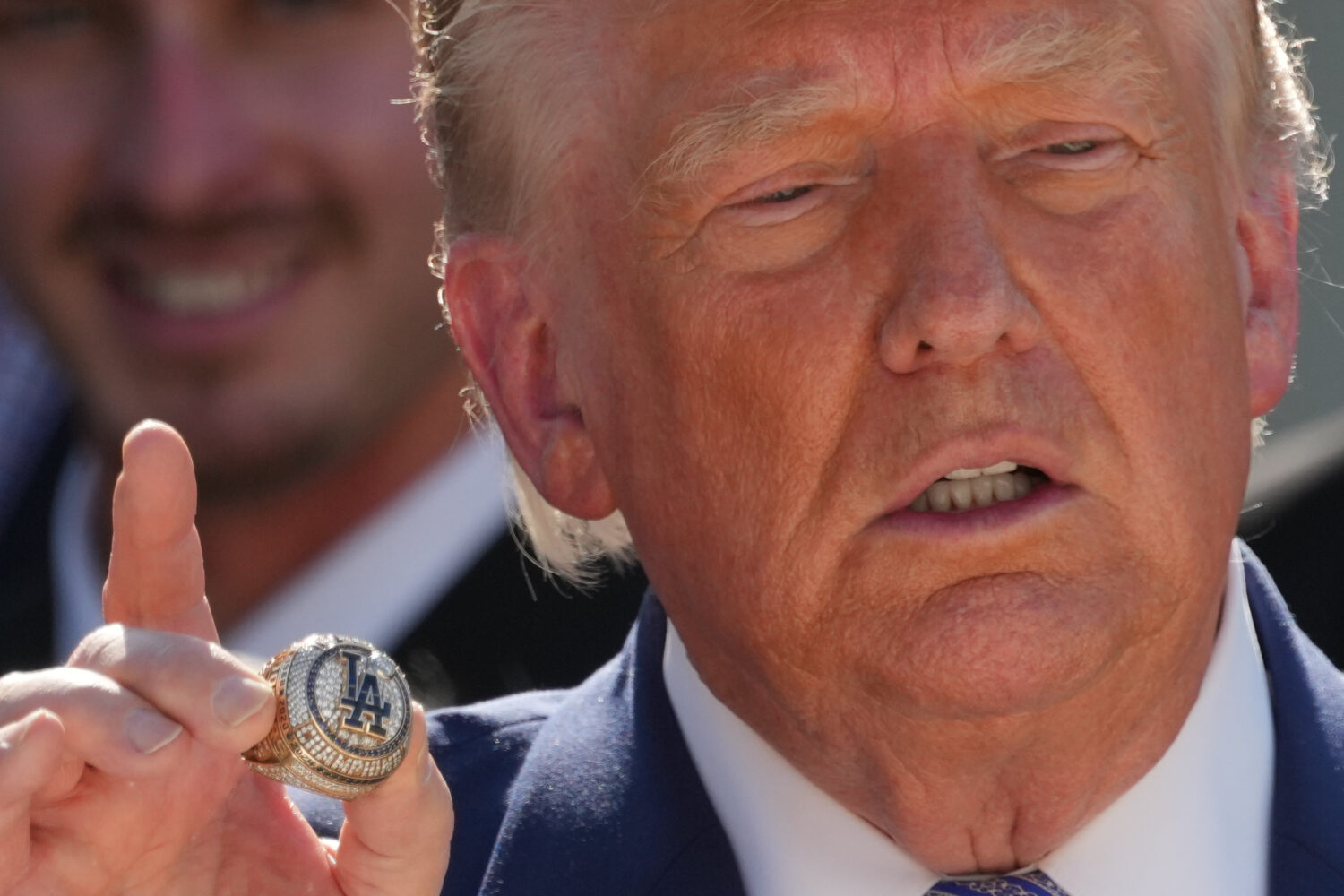 President Donald Trump holds a championship ring during an event to honor the 2025 World Series cha...