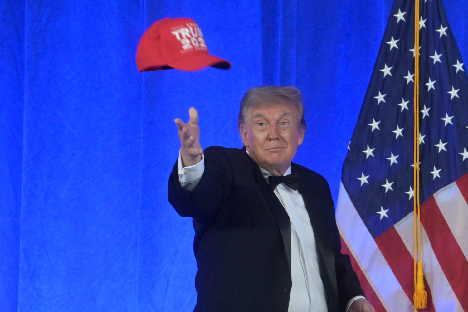 President Donald Trump tosses a "Trump 2028" hat at the White House Correspondents' Association din...