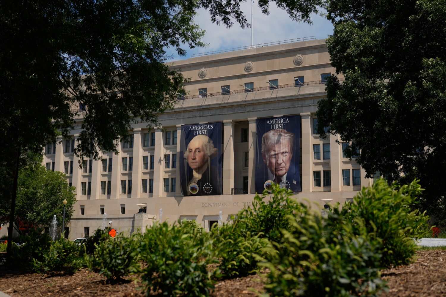 Banners of former President George Washington and President Donald Trump hang above an entrance to ...