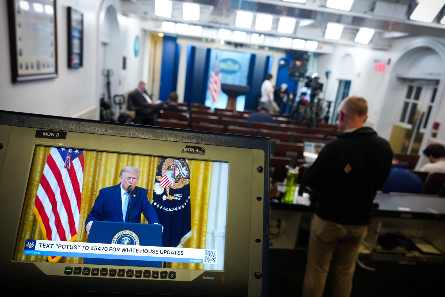 President Donald Trump is seen speaking from the East Room of the White House on a television scree...