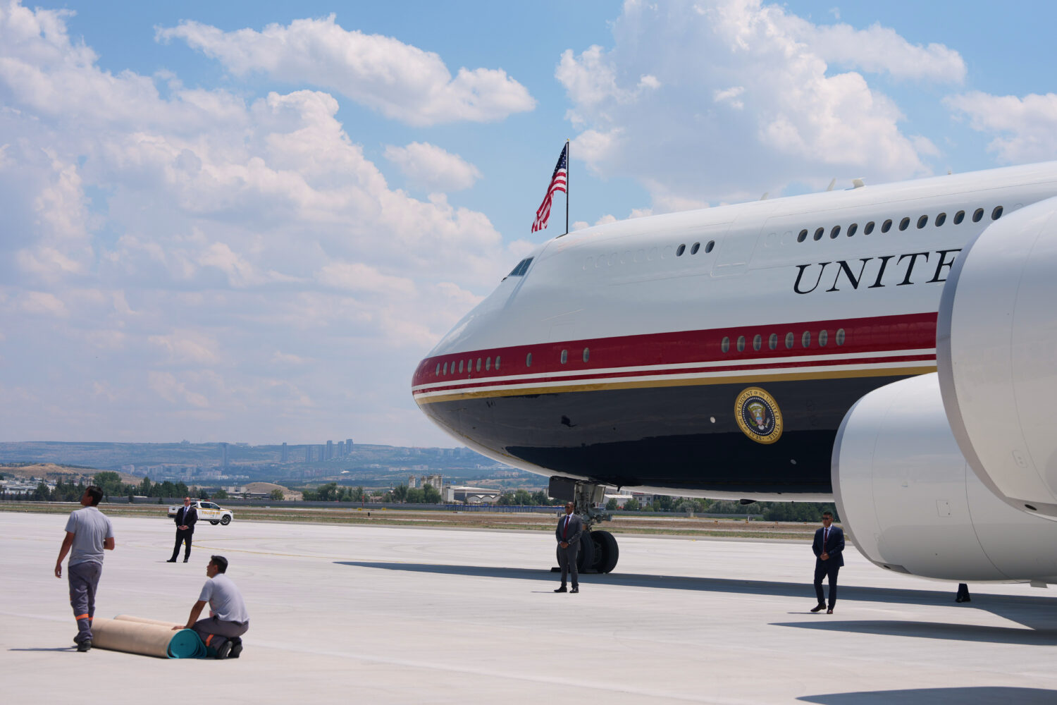 Staff lay a carpet on the tarmac before President Donald Trump exits Air Force One upon arriving fo...