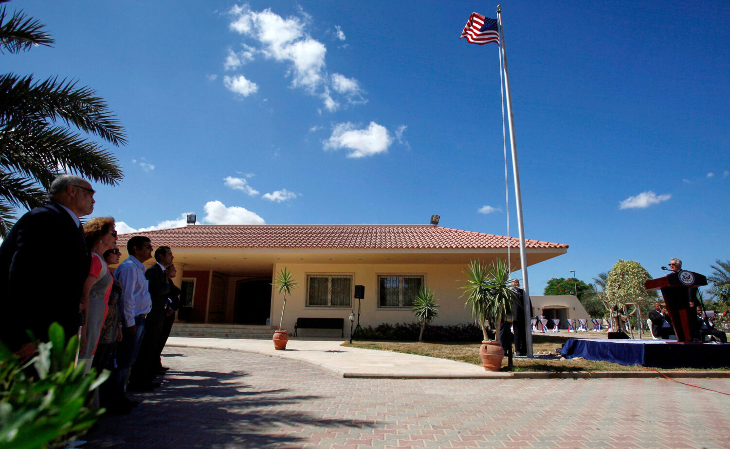 FILE - U.S. Ambassador to Libya Gene A. Cretz, right, stands at the podium during a flag raising ce...
