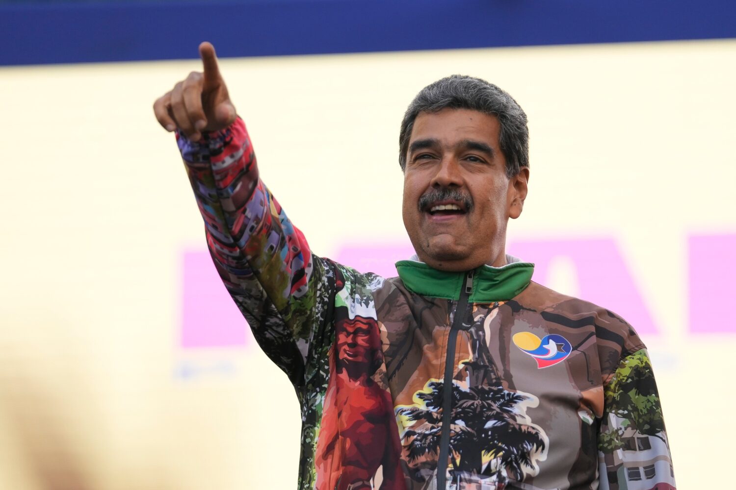 FILE - Venezuelan President Nicolas Maduro points to supporters during a campaign rally in the Cati...