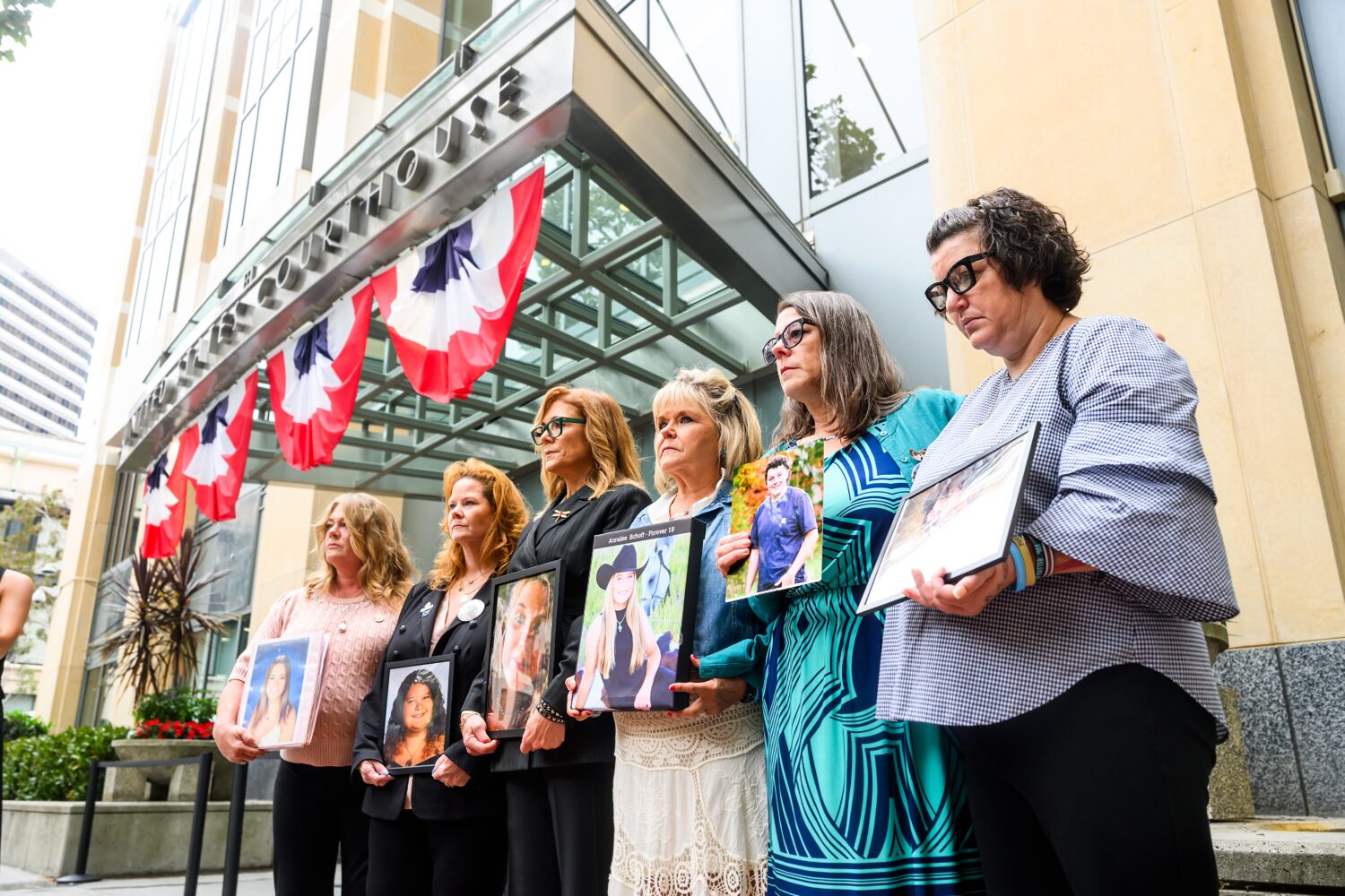 Parents hold pictures of their deceased children during a protest against social media platforms ou...