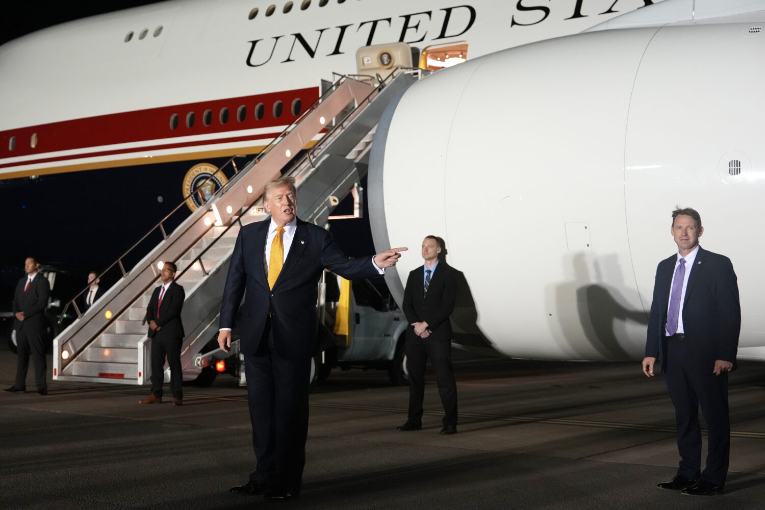 Surrounded by security, President Donald Trump switches planes at U.S. Air Force Base, RAF Mildenha...