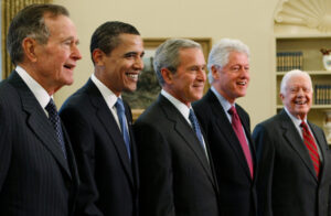 Trump goes unmentioned but not ignored as Clinton, Bush and Obama step up as essayists on presidents