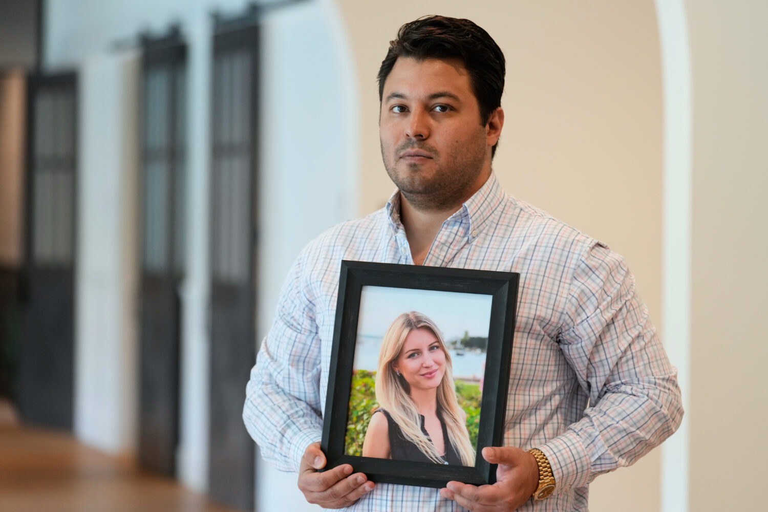 Harold Jezler poses for a picture with a photo of his wife, Olga Jezler, in West Harrison, N.Y., Fr...