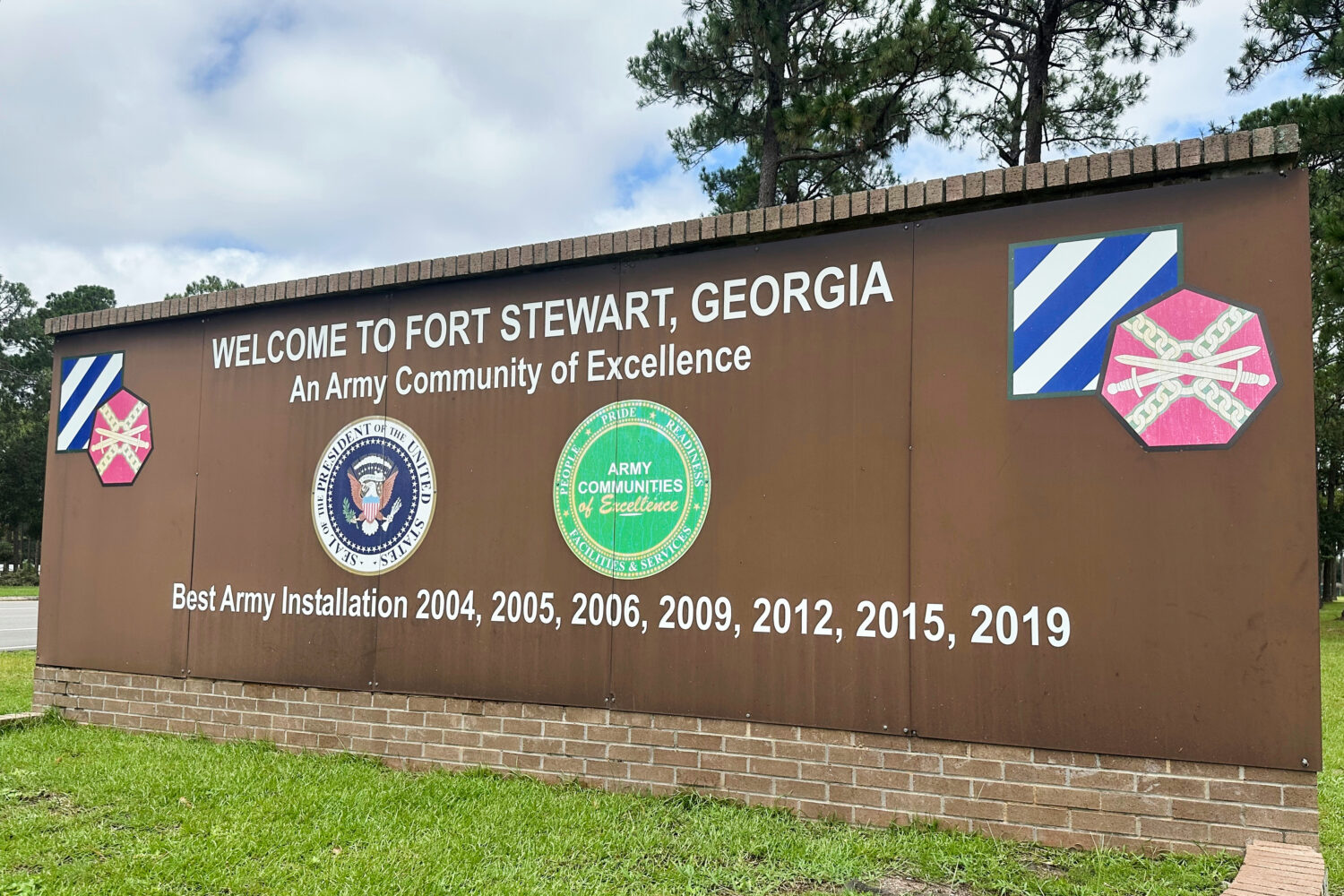 FILE - A sign stands outside the main gate of Fort Stewart, Ga., Aug. 6, 2025. (AP Photo/Russ Bynum...