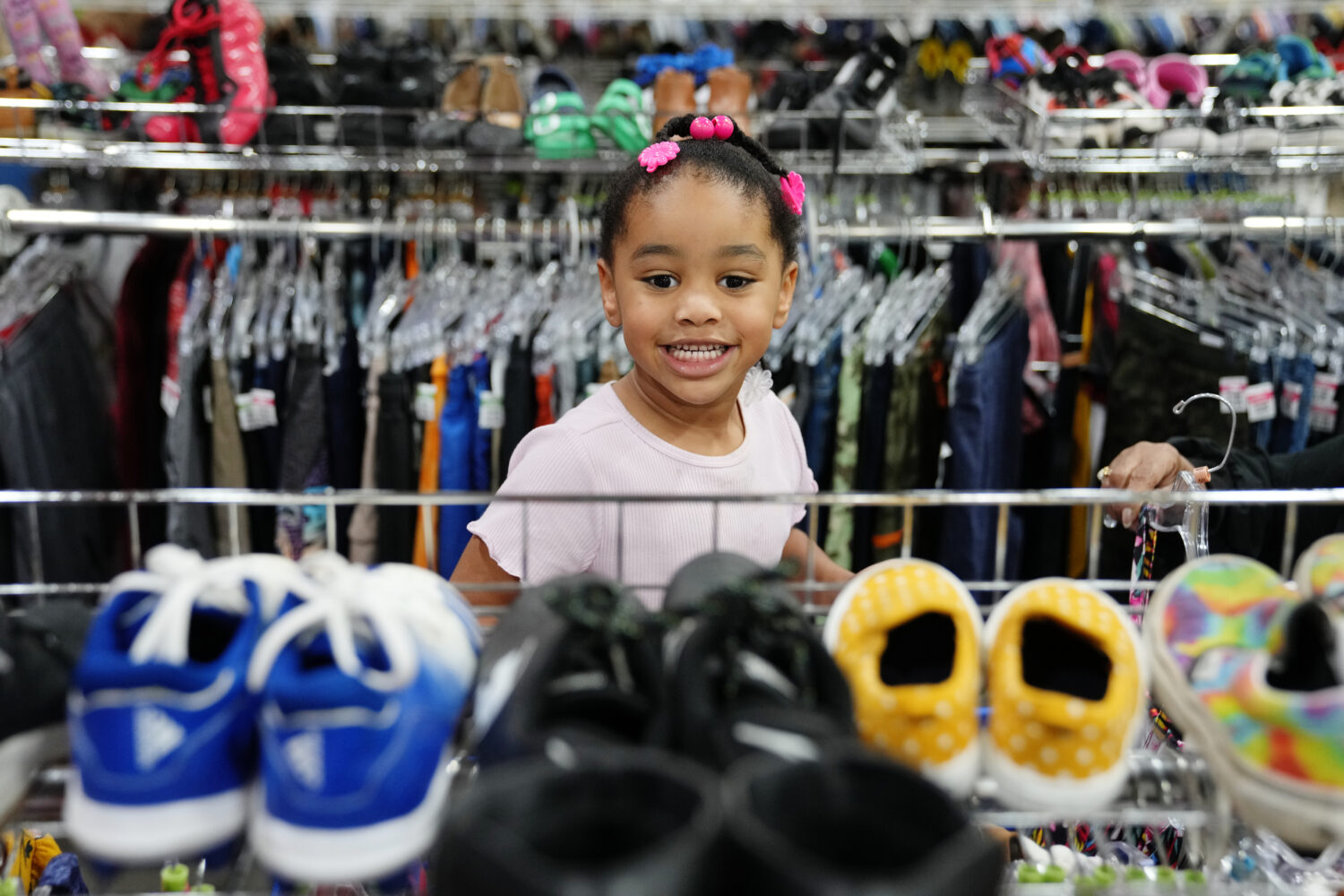 Deanna Pearson, 4, browses the children's shoe section at a Goodwill store in Roseville, Minn., Wed...