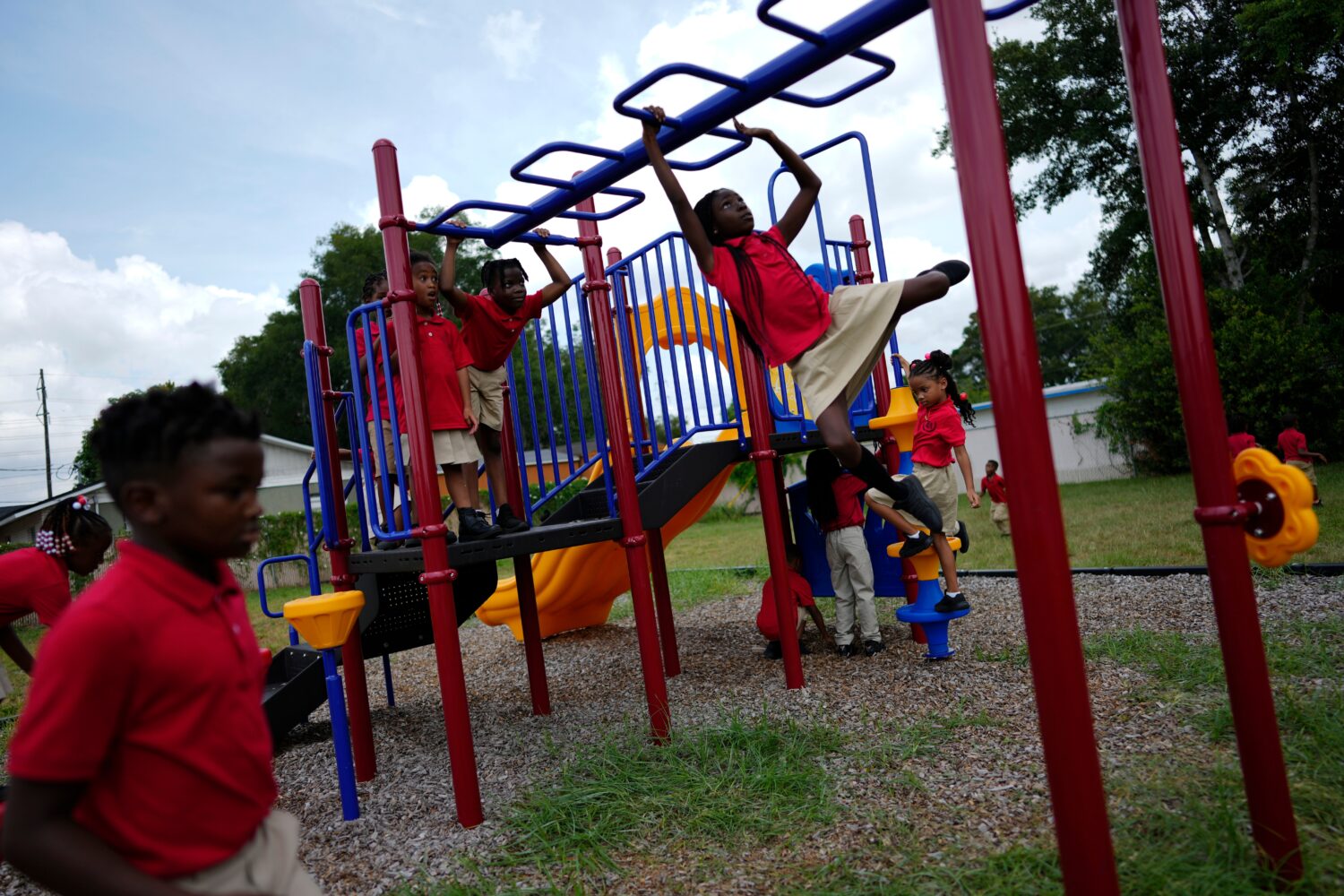 FILE - Students from Thomas Leadership Academy play on the school's playground in Eatonville, Fla.,...