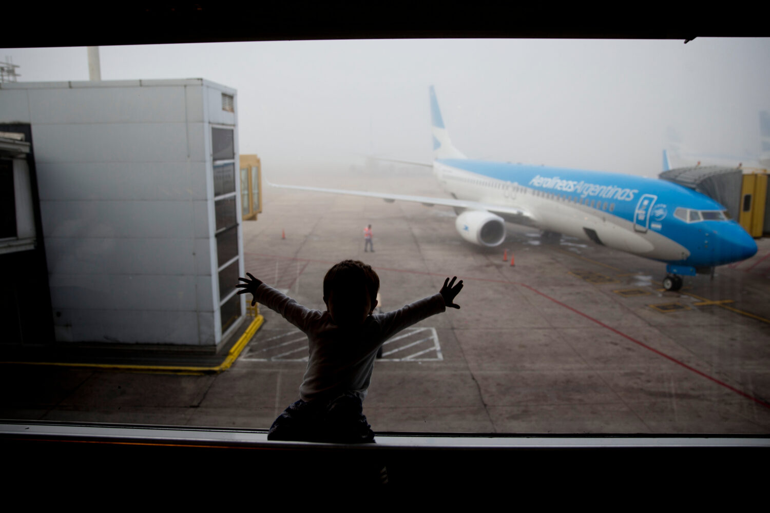 FILE - A child watches a plane at the Jorge Newbery airport in Buenos Aires, Argentina, April 14, 2...