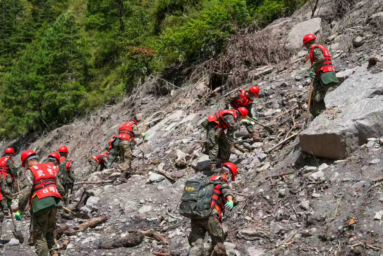 In this photo released by Xinhua News Agency, rescuers from the People's Armed Police Force work at...