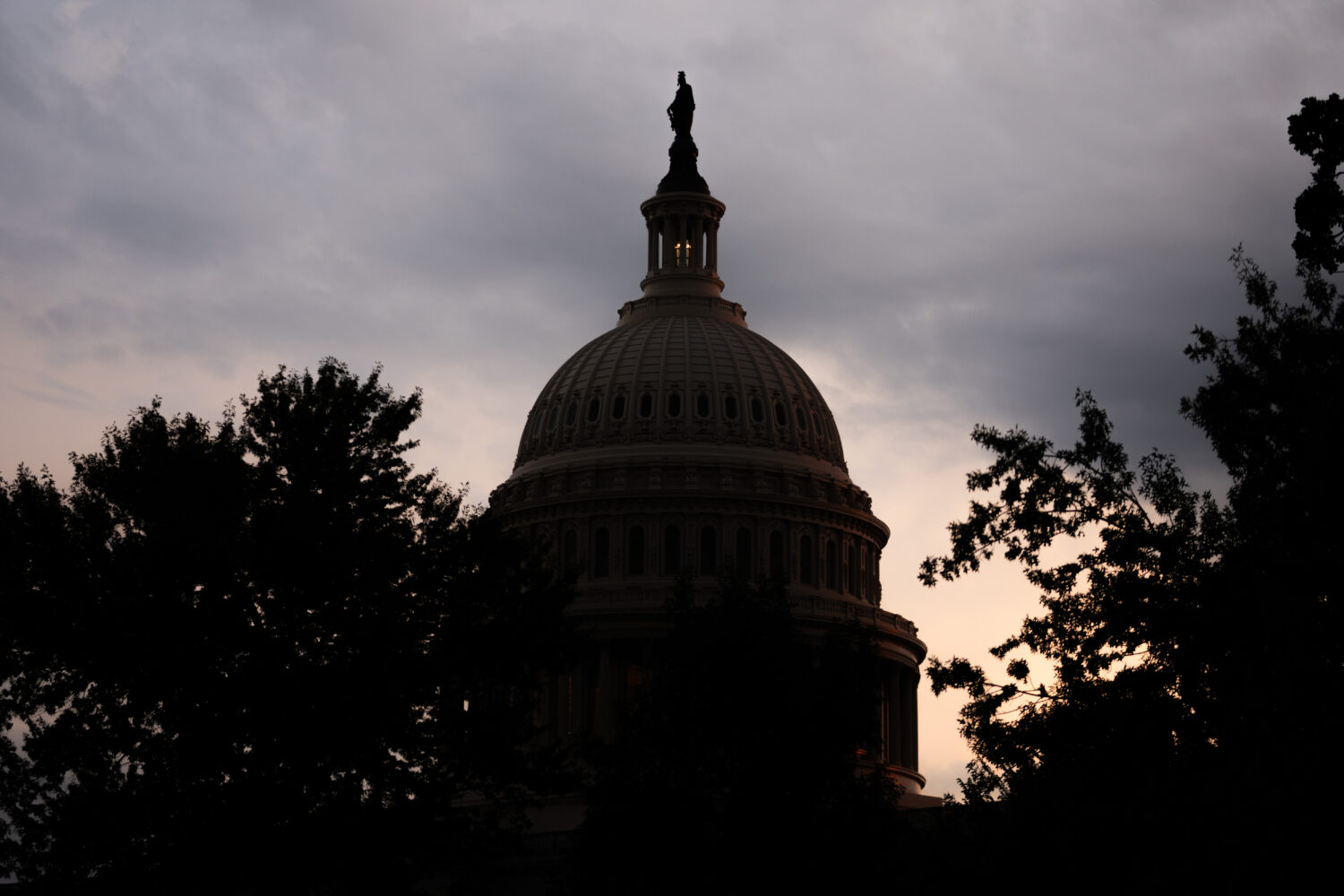 The sun sets behind the U.S. Capitol, Tuesday, July 28, 2026, in Washington. (AP Photo/Allison Robb...