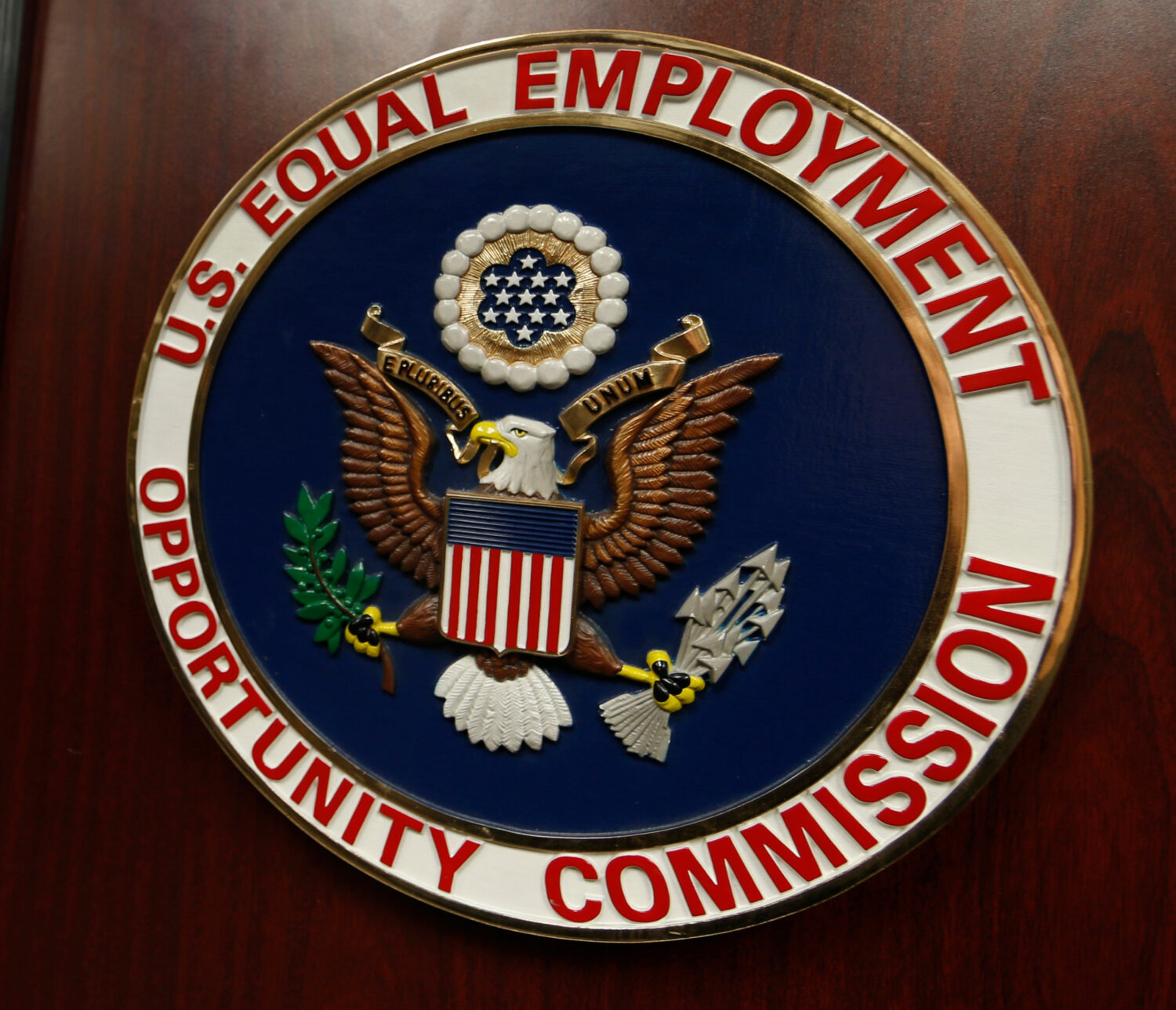 FILE - The emblem of the U.S. Equal Employment Opportunity Commission (EEOC) is displayed on a podi...