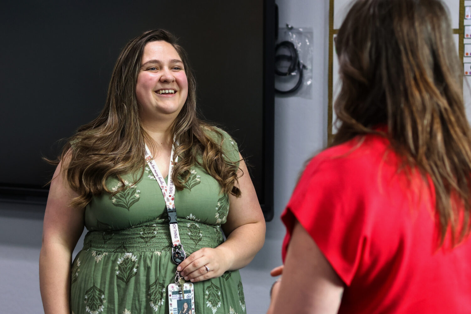 Elementary school teacher Emily Henderson speaks with the high school guidance counselor about back...