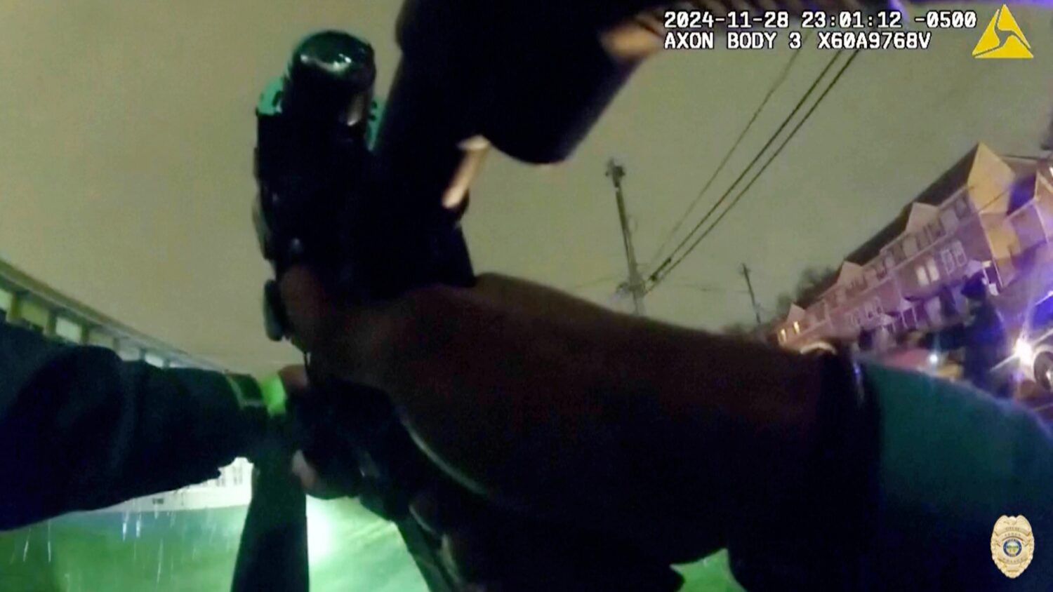 In this image from police body camera video provided by the Akron, Ohio Police Department, officers...