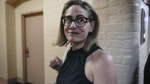 Then-Sen. Kyrsten Sinema walks to a vote at the U.S. Capitol on July 28, 2022, in Washington, D.C. (Drew Angerer/Getty Images)