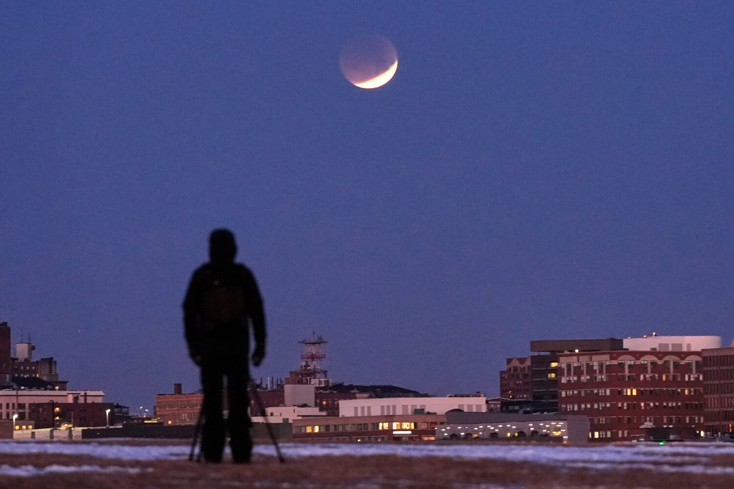 FILE - A man views the lunar eclipse, Tuesday, March 3, 2026, in South Portland, Maine. (AP Photo/R...