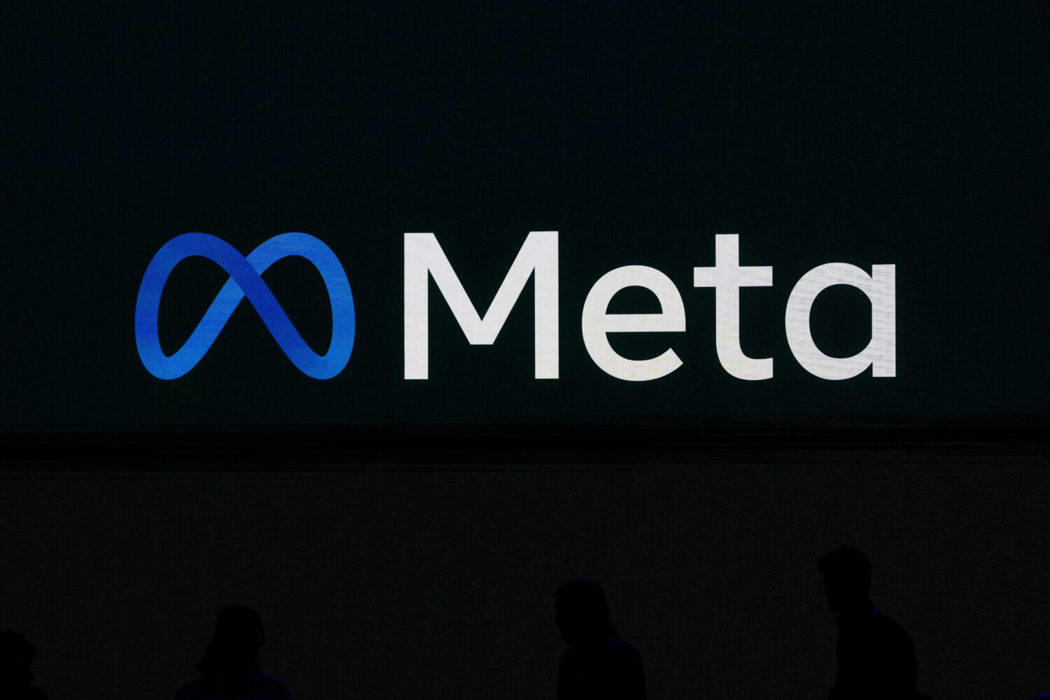 FILE - A Meta logo is shown on a video screen at LlamaCon 2025, an AI developer conference, in Menl...