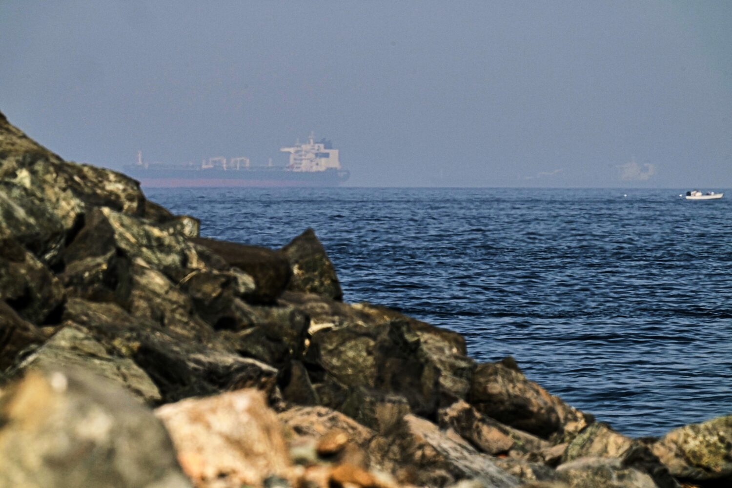 FILE - Cargo ships are seen at sea in the Gulf of Oman near the Strait of Hormuz, from a rocky shor...