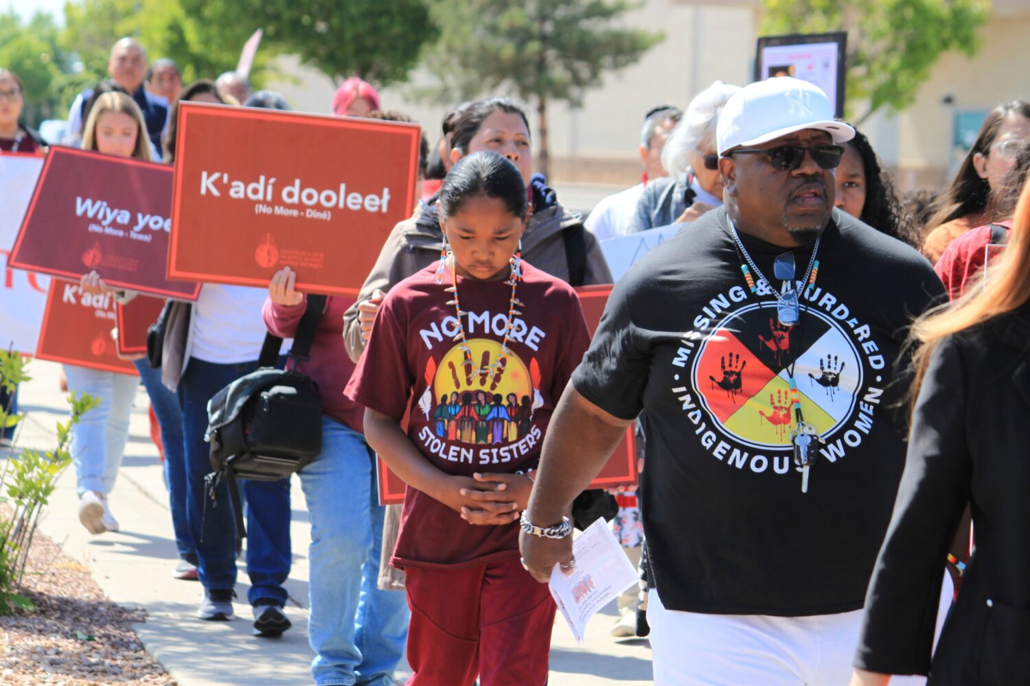 FILE - Tize W. Clark, right and his son, Zion Clark, participate in a walk to honor Native American...