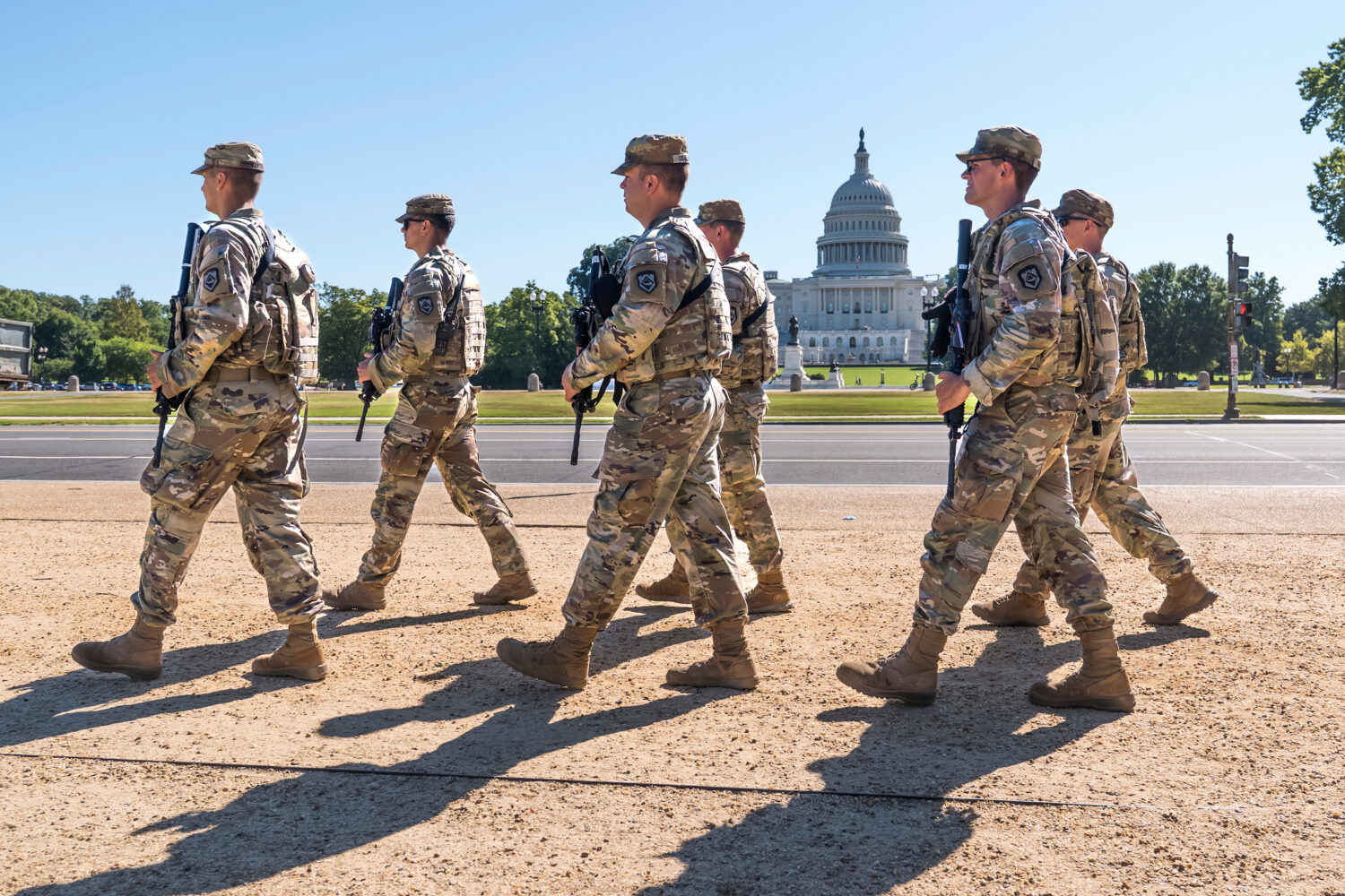 FILE - Armed National Guard soldiers from West Virginia patrol the Mall near the Capitol in Washing...