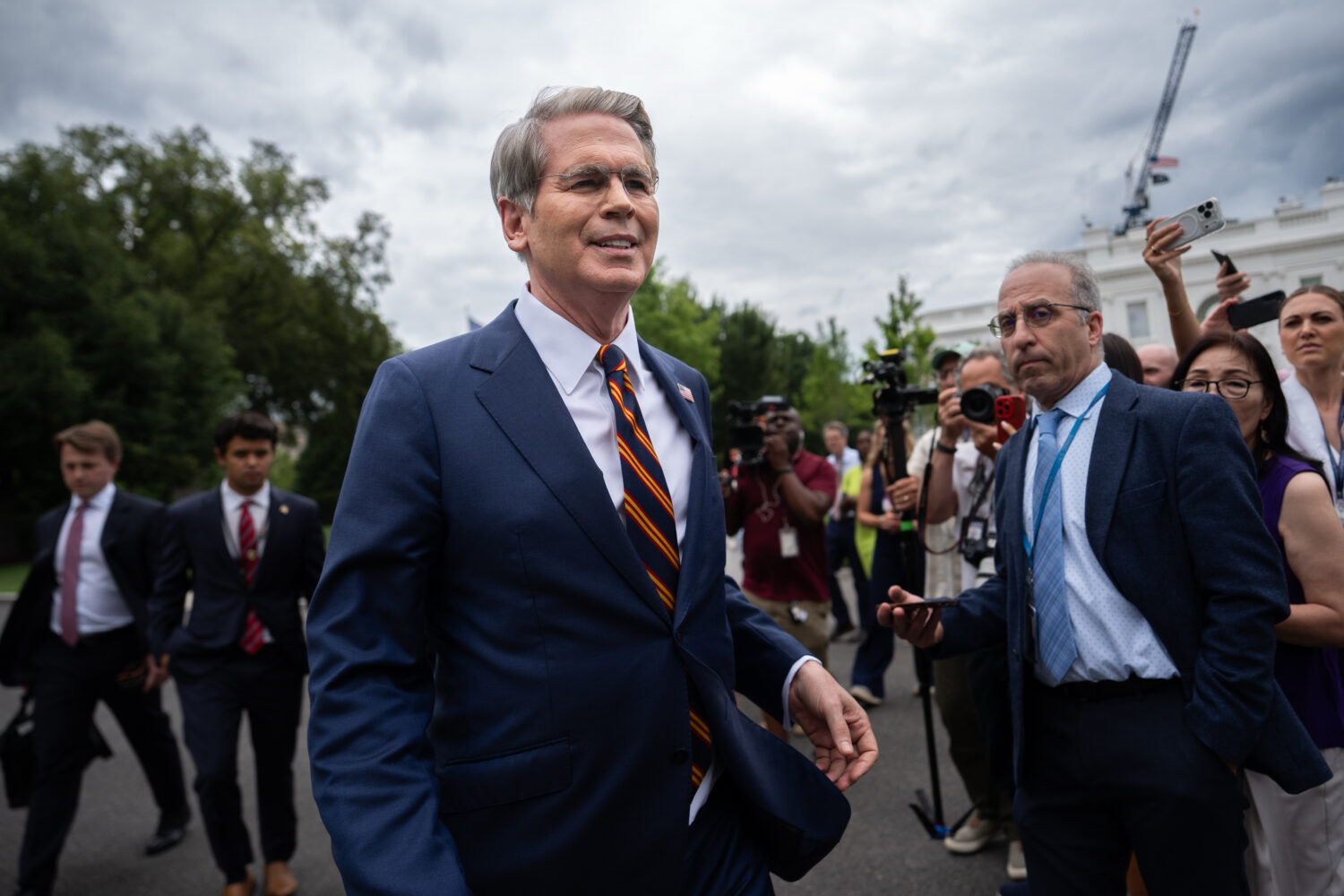 Treasury Secretary Scott Bessent walks past reporters following an interview with Fox News outside ...