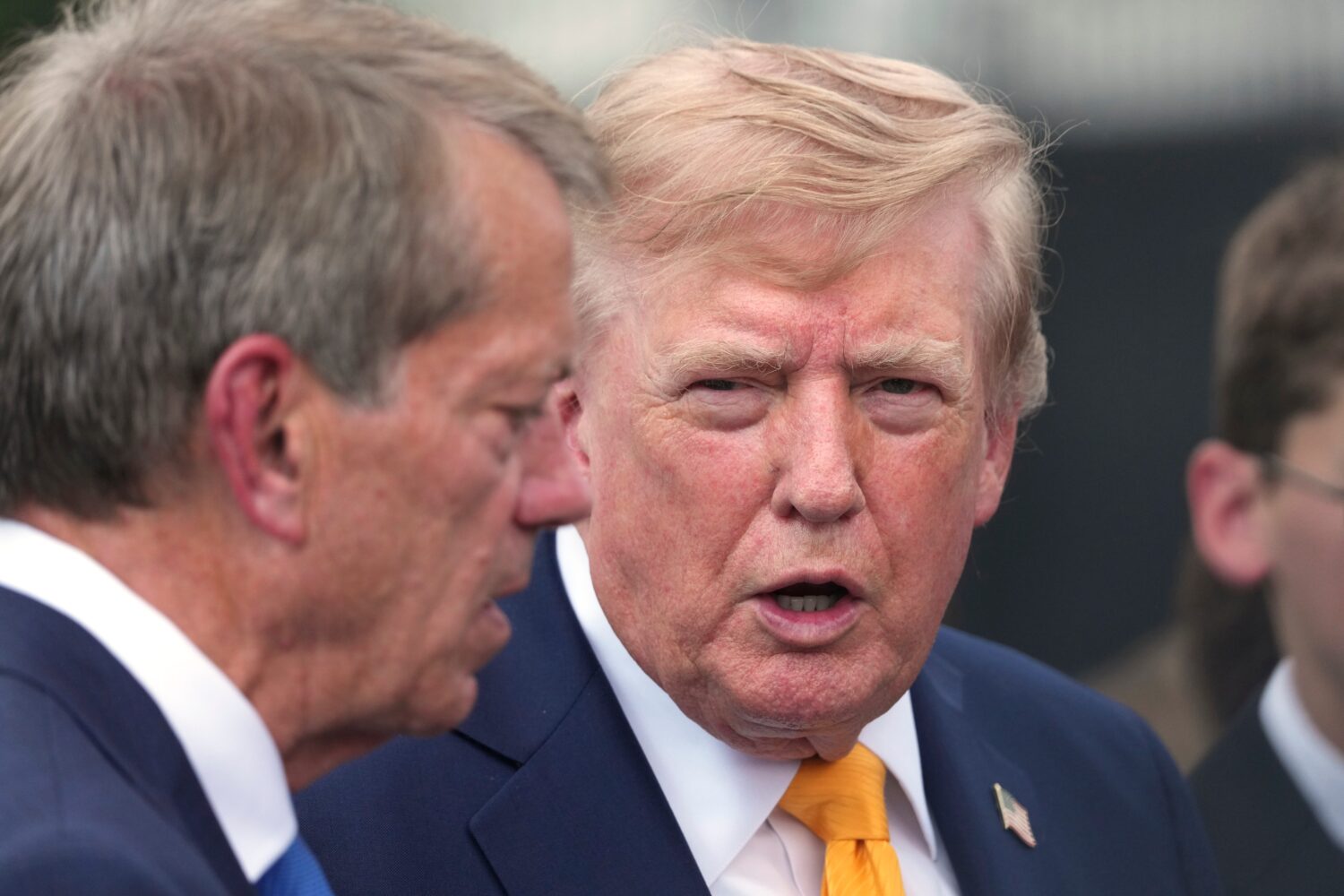 President Donald Trump speaks with Nebraska Gov. Jim Pillen after a back to school event in the Ros...