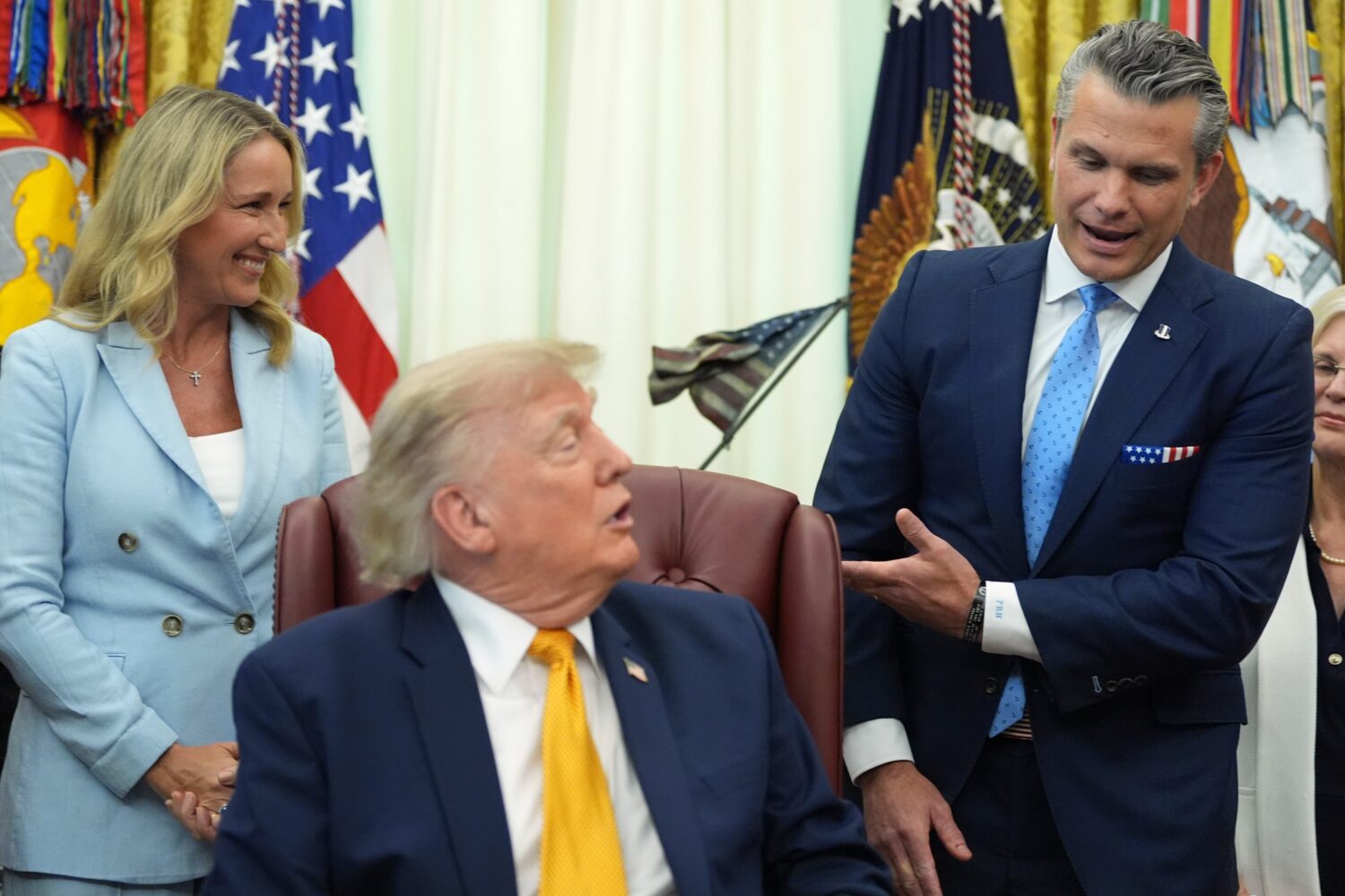 Defense Secretary Pete Hegseth, from right, speaks as President Donald Trump and Jennifer Hegseth l...