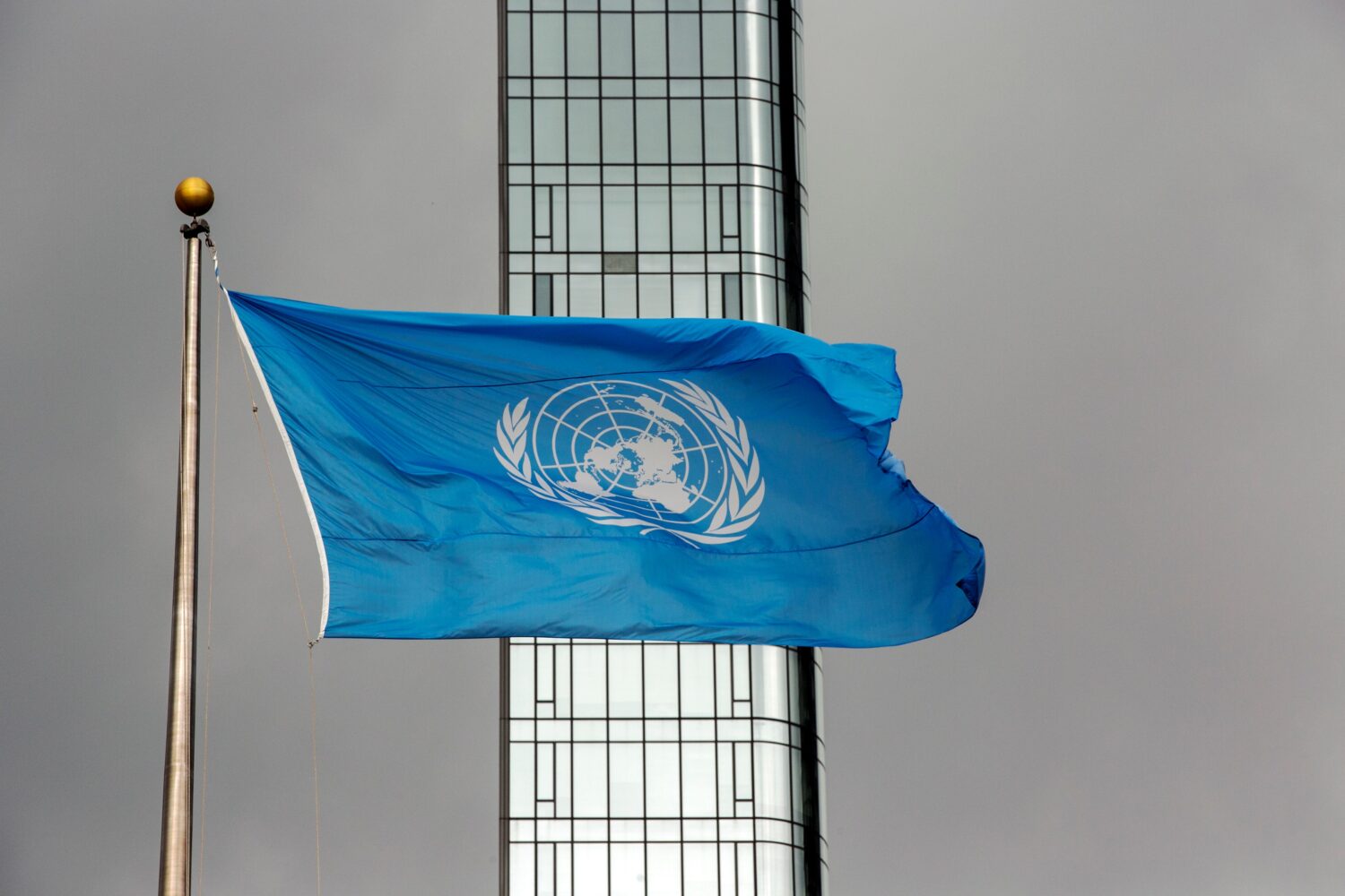 FILE - The UN flag flies on a stormy day at the United Nations during the United Nations General As...
