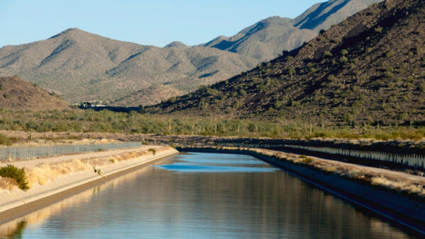 The Central Arizona Project canal carries Colorado River water through the desert toward Phoenix and Tucson. CAP delivers river water to nearly 6 million customers and faces 760,000 acre-feet in annual cuts over the next two years. (Central Arizona Project)