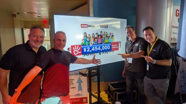 KTAR News 92.3 FM and Arizona Sports 98.7 FM staff and volunteers celebrate after the 18th annual Give-A-Thon for Phoenix Children's surpassed $2.46 million at the final bell Friday. (KTAR News 92.3 FM)