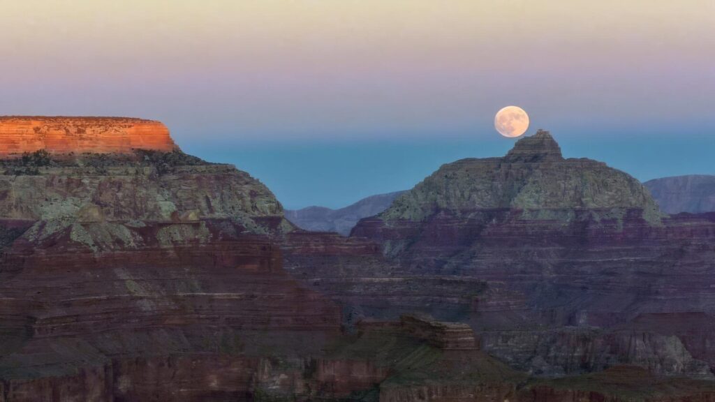The moon hangs above the Grand Canyon in this file photo. (Photo via National Park Service)