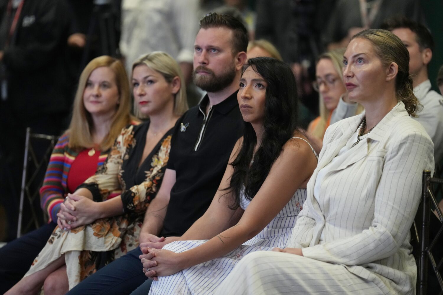 ADDS NAMES - Victims of Jeffrey Epstein sit in the front row, from left, Liz Stein, Dani Bensky, Sk...