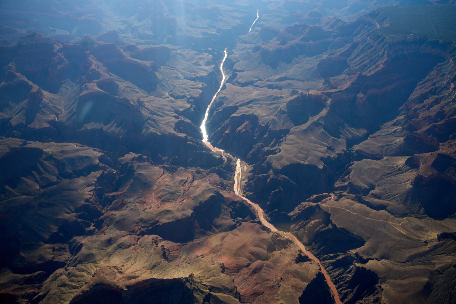 Bright Angel Canyon, middle left, the scene of flash floods, meets with the Colorado River in the G...