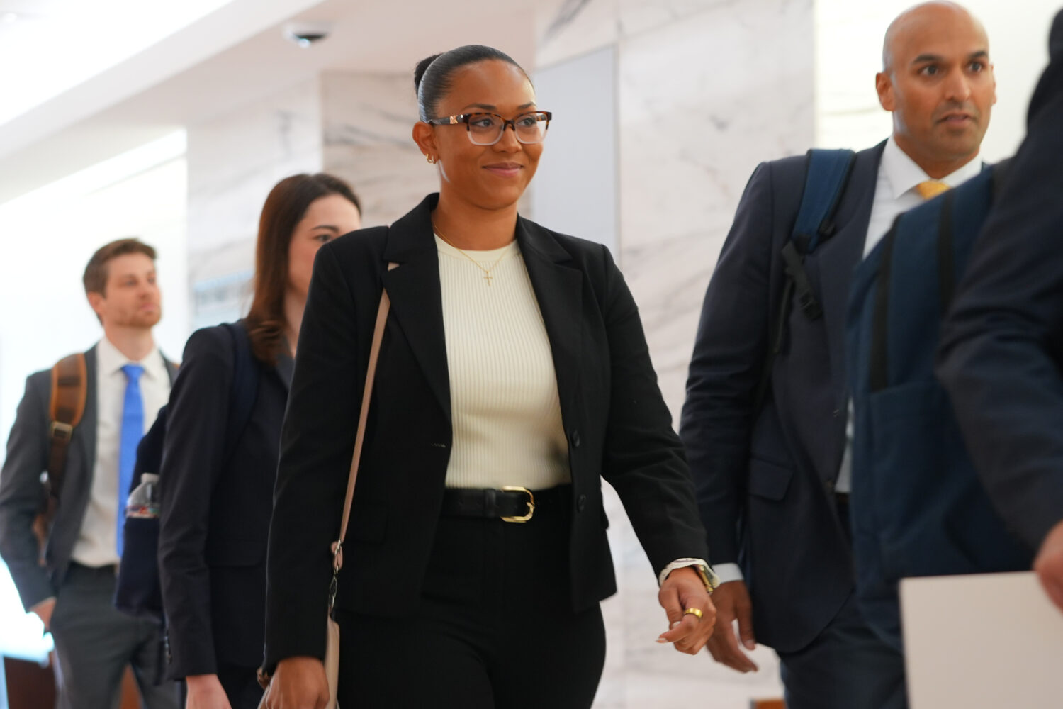 McKenna West, left, arrives with her legal team for a court hearing in Dallas, Tuesday, Aug. 25, 20...