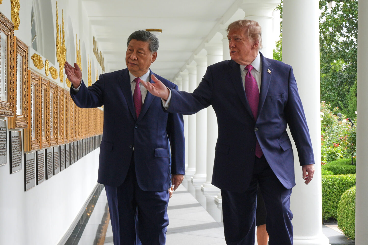 President Donald Trump and China's President Xi Jinping walk along the Colonnade of the White House...