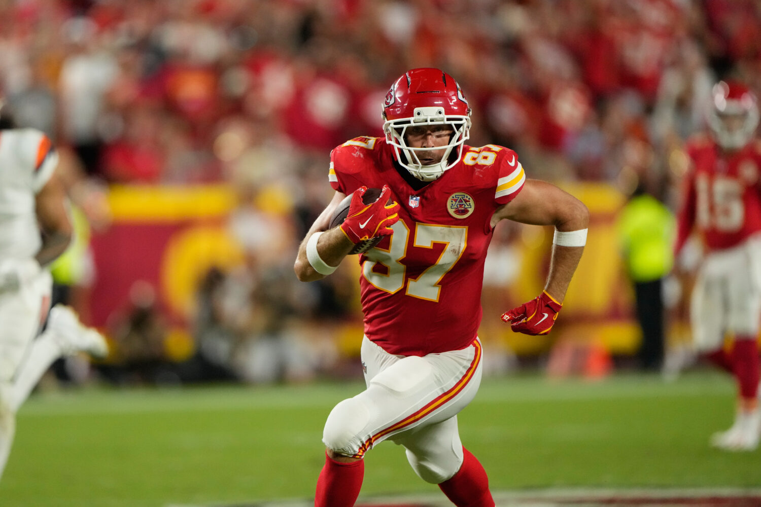 Kansas City Chiefs tight end Travis Kelce runs the ball after making a catch against the Denver Bro...