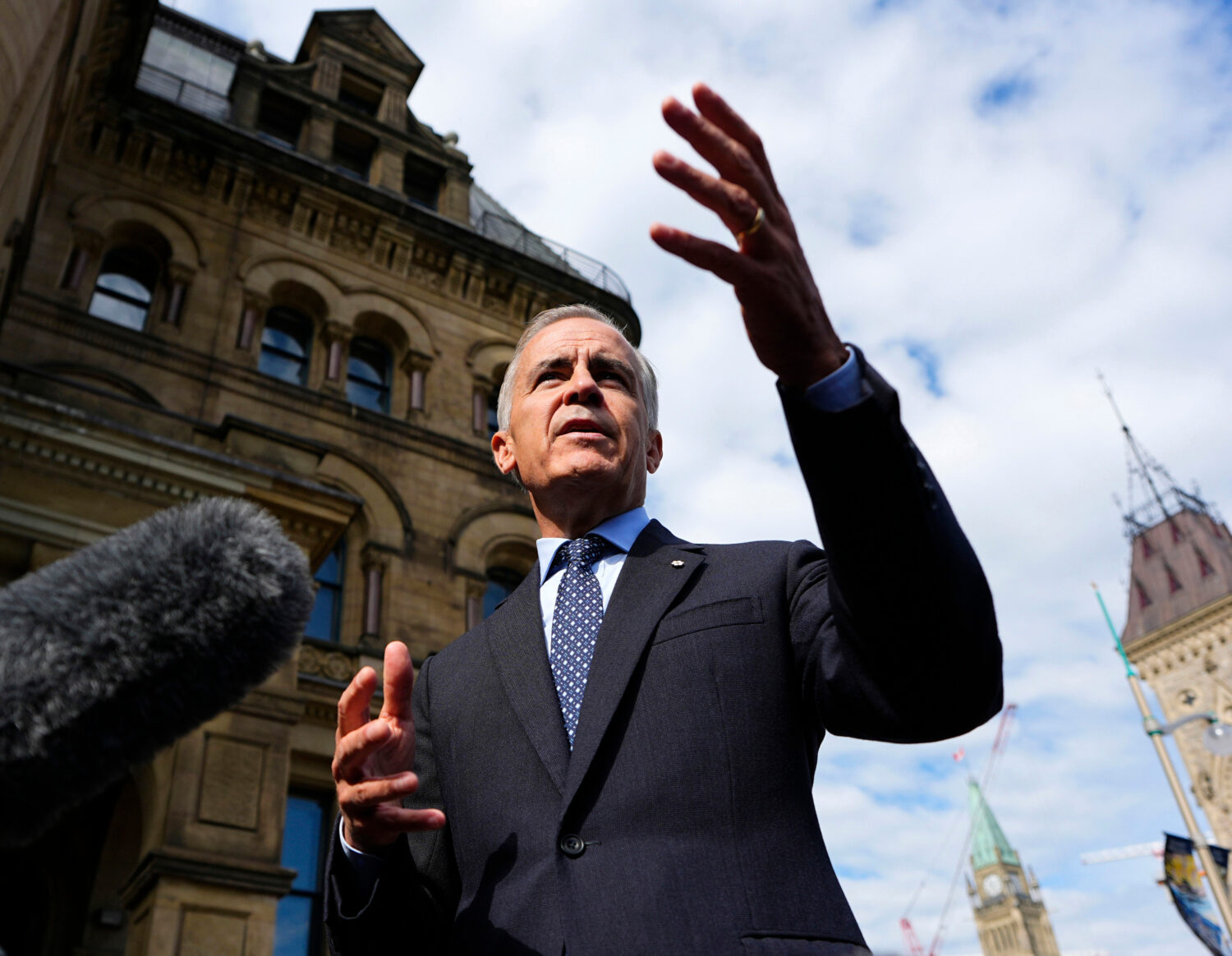 Prime Minister Mark Carney speaks to journalists as he arrives at the Office of the Prime Minister ...