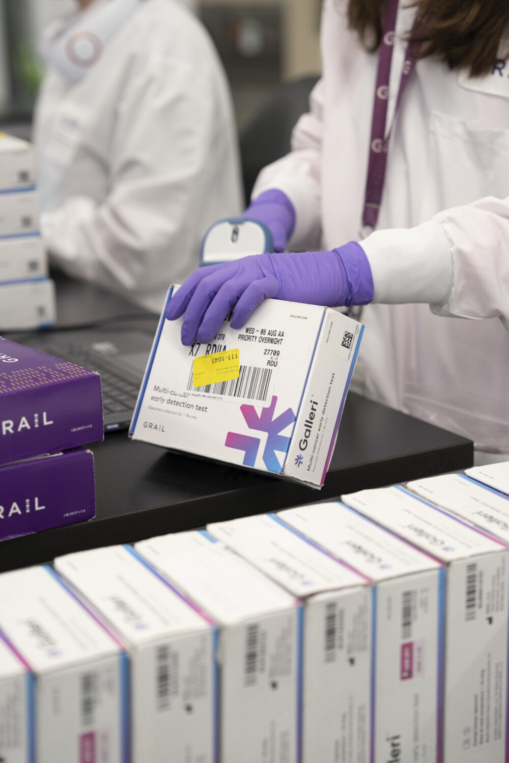 This undated photo provided by Grail Inc. on Tuesday, Sept. 22, 2026, shows an employee scanning a ...