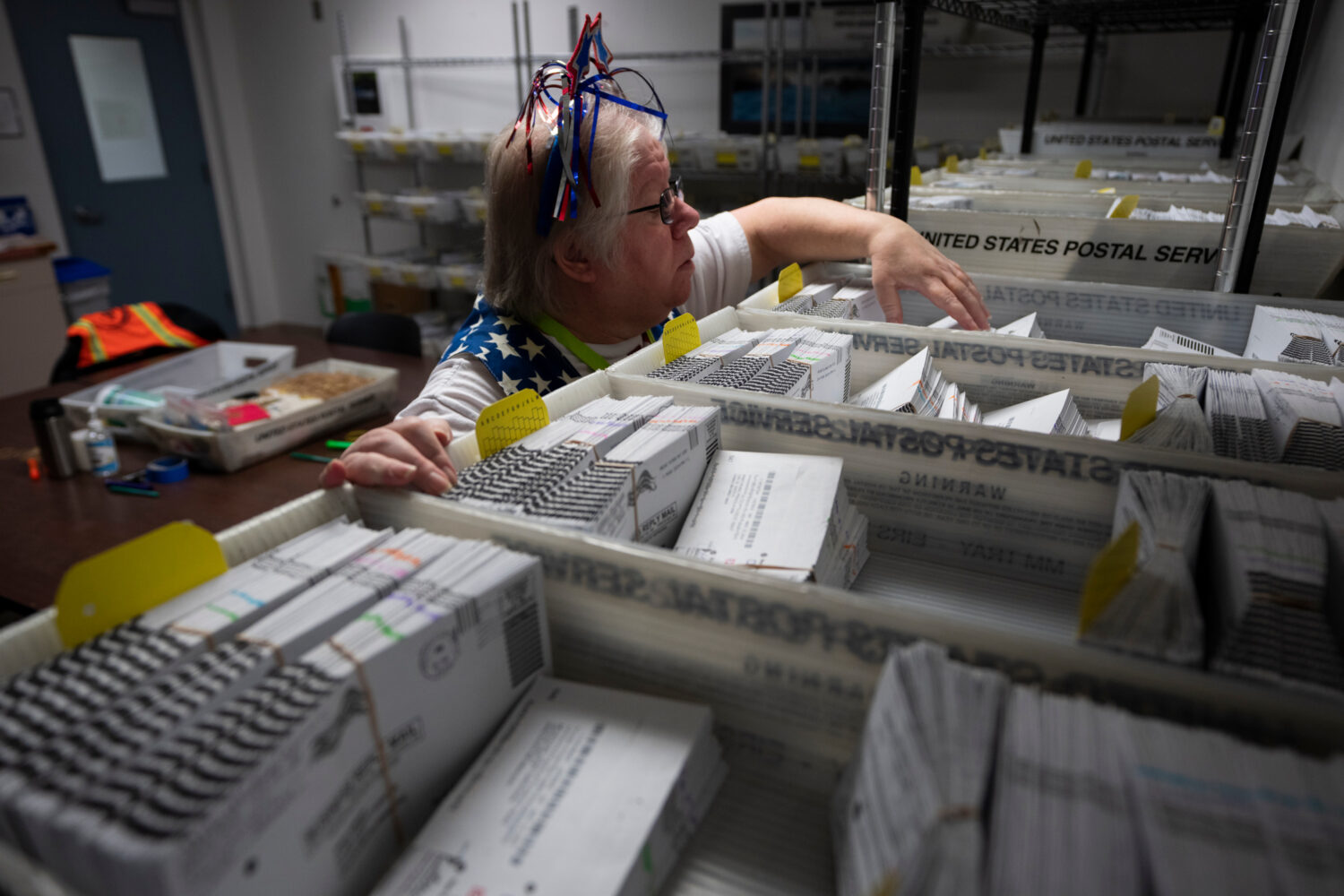 FILE - Election worker Wendy Wimer looks through vote-by-mail ballots for the presidential primary ...