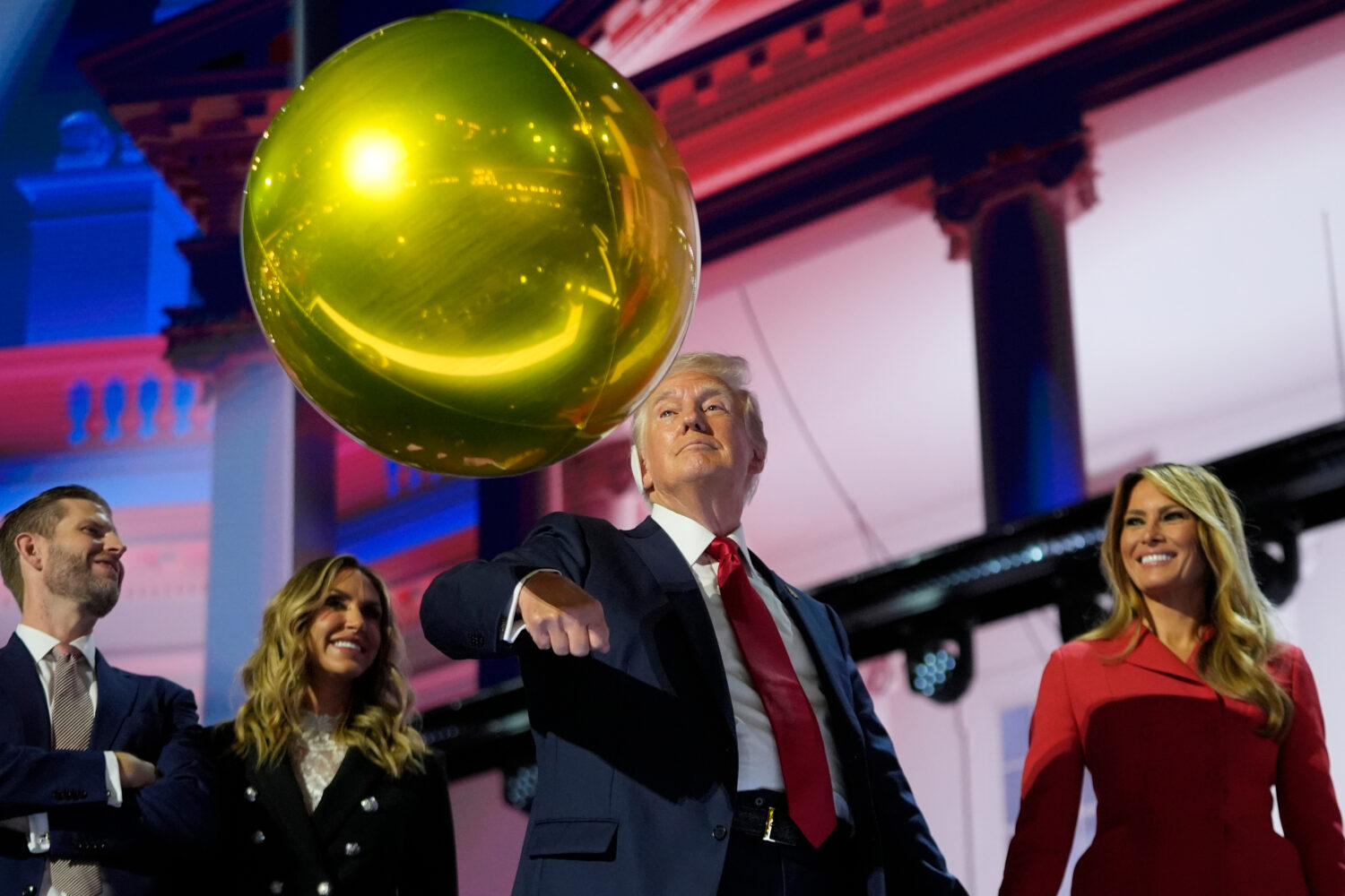 FILE - Republican presidential candidate former President Donald Trump hits a balloon during the fi...