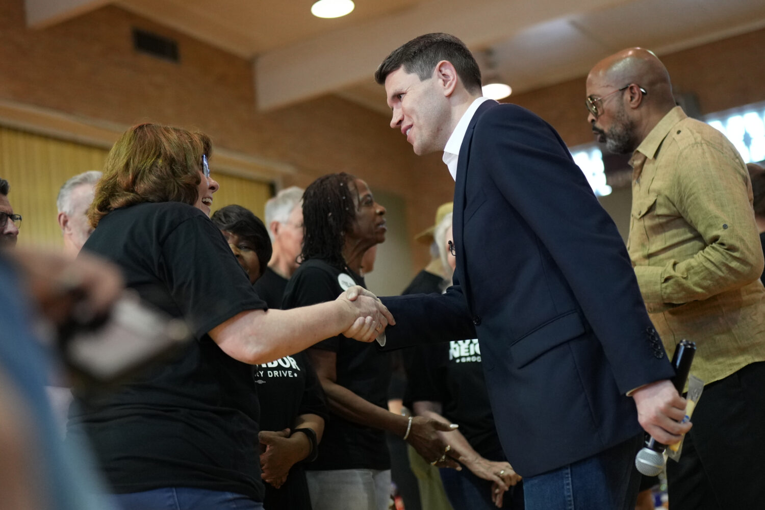 Democratic U.S. Senate candidate Texas state Rep. James Talarico talks with volunteers at a food dr...